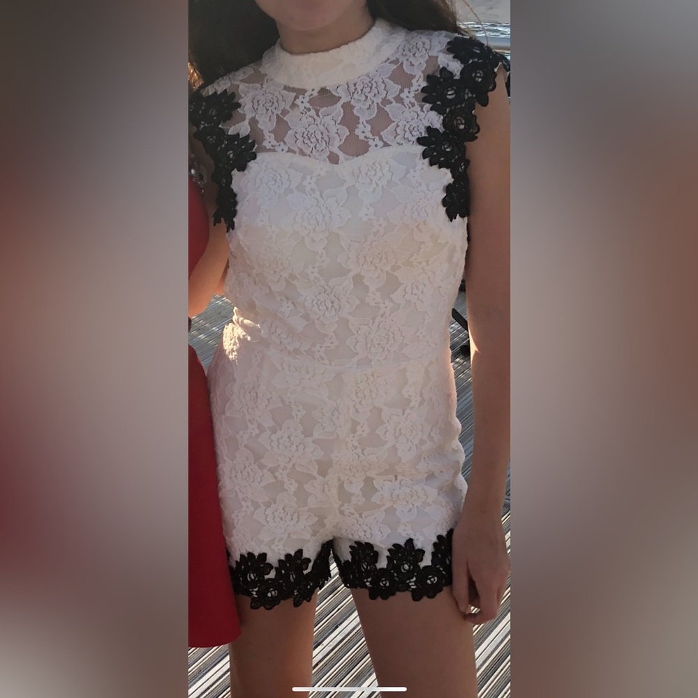 White lace romper with black trim
